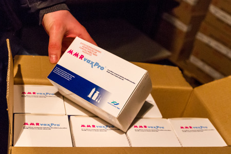 Uzhgorod, Ukraine - March 16, 2017: An employee of the Red Cross Society demonstrates the boxes with the measles vaccine, which entered the Transcarpathian region within the framework of humanitarian aid from Hungary.のeditorial素材