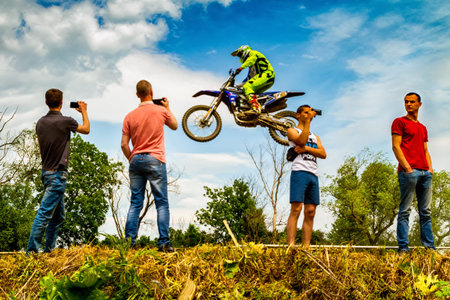 Uzhgorod, Ukraine - May 21, 2017: Spectators photograph a race for mobile phones during the Championship of Zakarpatie region on motocross in Uzhgorod, Ukraine, May 21, 2017.のeditorial素材