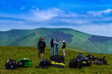 Pylypets, Ukraine - June 25, 2017: Tourists resting after climbing on a mountain top Hymba in the Carpathian mountains near the village Pylypets.のeditorial素材