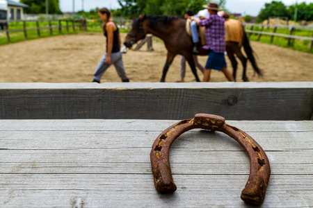 Vynohradiv, Ukraine - July 12, 2017: Horseshoe on fence racecourse in summer children's equestrian sports camp.のeditorial素材