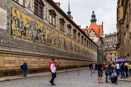 Dresden, Germany - July 26, 2017: Tourists walk near the famous wall tile mural from Meissen porcelain Procession of princes in the historical part of beautiful Dresden.のeditorial素材