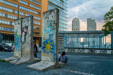 Berlin, Germany - July 27, 2017: Tourists are resting at the remains of the Berlin Wall on Potsdamer Platz in the evening light.のeditorial素材