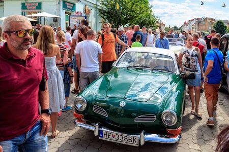 People view cars at the exhibition and parade of vintage cars in the city center in Uzhgorod, Ukraine, June 29, 2019.のeditorial素材