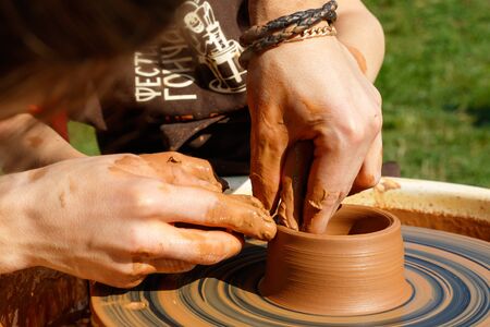 Hands of potters while working with clay during the Second Pottery Festival, in Uzhgorod, October 19, 2019.のeditorial素材