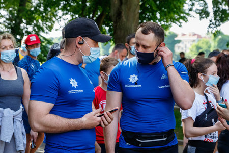 Uzhgorod, Ukraine - June 7, 2020: Police officers in medical masks talk before the start of the...