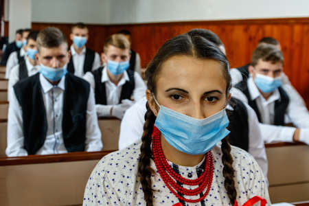 Piyterfolvo, Ukraine - October 8, 2020: Youth in protective masks pray in the local Hungarian Reformed Church during coronavirus pandemic.のeditorial素材