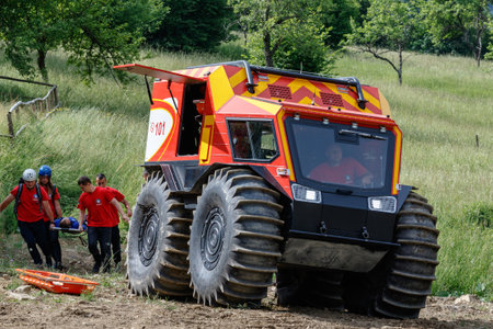 Nizhniy Studeny, Ukraine - July 2, 2021: Ukrainian mountain rescuers, after providing first aid, evacuate a tourist injured in the mountains on a Bohun snow and swamp-going vehicle.のeditorial素材