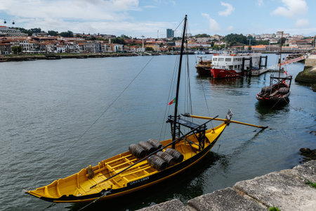 Porto, Portugal - September 9, 2021: Traditional Rabelo boats with port wine against the backdrop of...