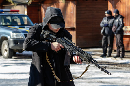 Uzhhorod, Ukraine - February 13, 2022: A young man examines a modernized Kalashnkov assault rifle...