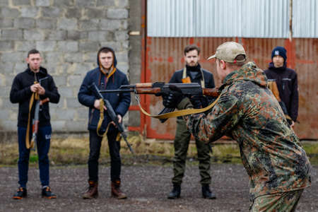Uzhgorod region, Ukraine - February 19, 2022: Civilians in Ukraine are training in one of the abandoned factories to defend their country in case of Russian invasion.のeditorial素材