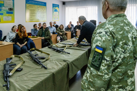 Uzhhorod, Ukraine - March 3, 2022: Local people learn the basics of handling firearms. Defense of...