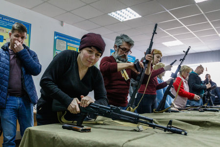 Uzhhorod, Ukraine - March 3, 2022: Local people learn the basics of handling firearms. Defense of Ukraine from Russian aggression.のeditorial素材