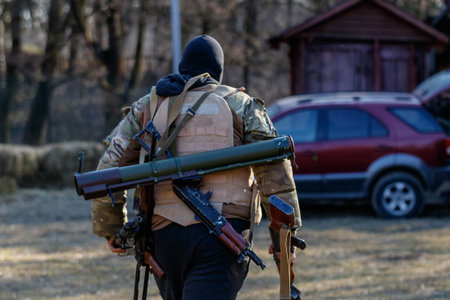 Western Ukraine - March 13, 2022: Ukrainian youth spend their free time with weapons in their hands, preparing for war with the Russian occupier.のeditorial素材