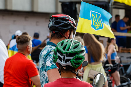 Uzhhorod, Ukraine - June 26, 2022: Flag of Ukraine on the helmet of a participant in a charity bike ride in support of the Armed Forces of Ukraine before the start.のeditorial素材