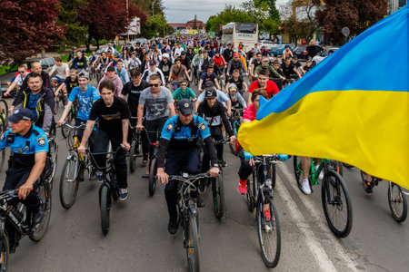 Uzhhorod, Ukraine - 7 May 2023: Participants of a charity bike ride in support of the Armed Forces of Ukraine ride bicycles in the city center. Event, a big charity bike ride.のeditorial素材