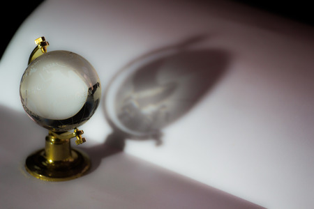 Glass globe with light and shadowの写真素材