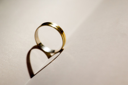 Wedding ring with heart shadow .の写真素材
