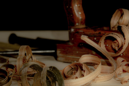 old woodworks tools: wooden planer, hammer, chisel in a carpentry workshop on wood background