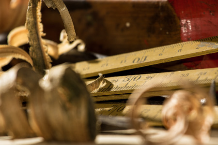 Curled wooden shaving on wooden backgroundの写真素材