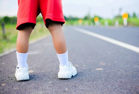 foot of a girl on the street asphalt conceptの写真素材