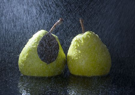 Pear is a fruit that has a yellow or green skin and is white inside. Pears are thinner at the top (i.e. where they join onto the tree) than at the bottom.の写真素材