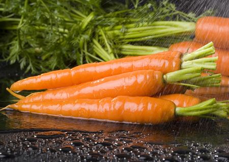 The carrot is a root vegetable, typically orange or white in colour with a woody texture.の写真素材