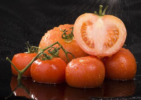 Tomato - is a cultivated plant. It is commonly cultivated because of its juicy fruits, which are full of vitamins, nutritions and mineral salts.の写真素材