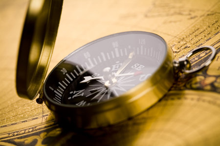 Old-fashioned compass on map 