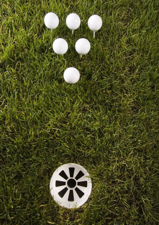 Golf ball on tee in grass の写真素材