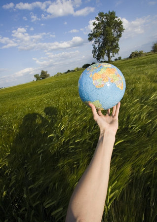 Globe made from puzzles & hand 