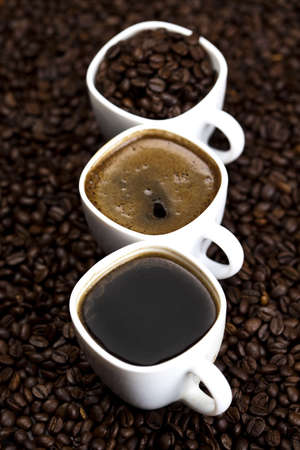 Coffee over dark roasted coffee beansの写真素材