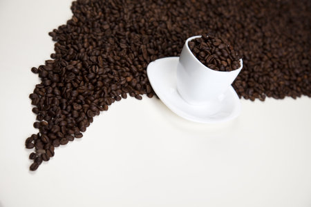 Cup with beans coffee on whiteの写真素材