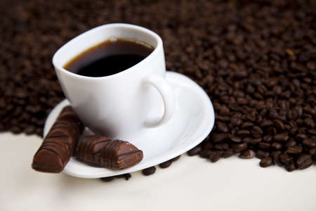 Cup with beans coffee on whiteの写真素材
