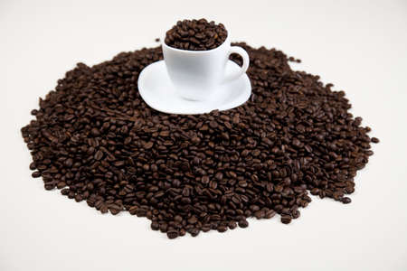 Cup with beans coffee on whiteの写真素材