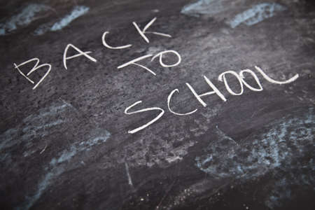 Inscription on a school chalkboard - back to school の写真素材