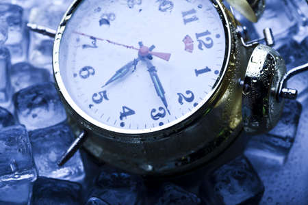 Classical alarm clock with ice cubesの写真素材