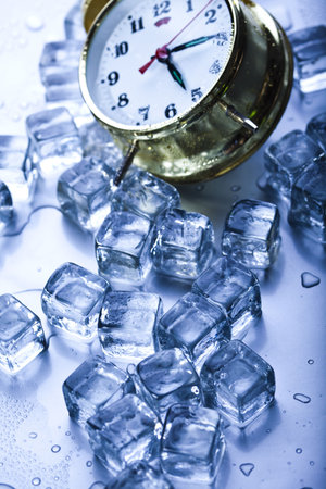 Classical alarm clock with ice cubesの写真素材