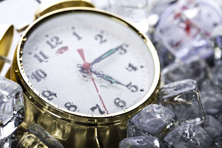Alarm colck among ice cubesの写真素材