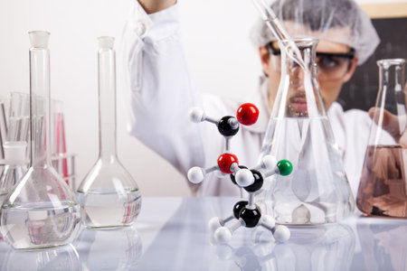 Scientist in laboratory examinates samples and chemical fluids
