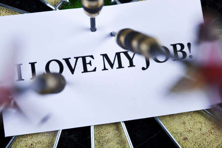 Dart on bulls eye target of dartboardの写真素材