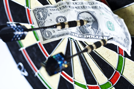 Dartboard with three darts in a bulls eye