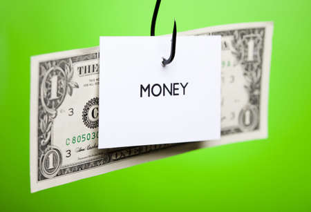 Dollar sign on piece of paper on hookの写真素材