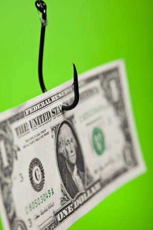 Dollar sign on piece of paper on hookの写真素材