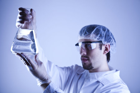 Scientist in laboratory examinates samples and chemical fluids