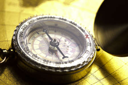 Antique brass compass over old mapの写真素材