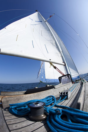 Winch with rope on sailing boat in the sea 