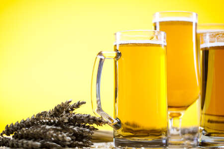 Beer glass with yellow background の写真素材