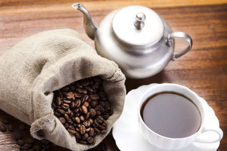 Coffee over dark roasted coffee beansの写真素材