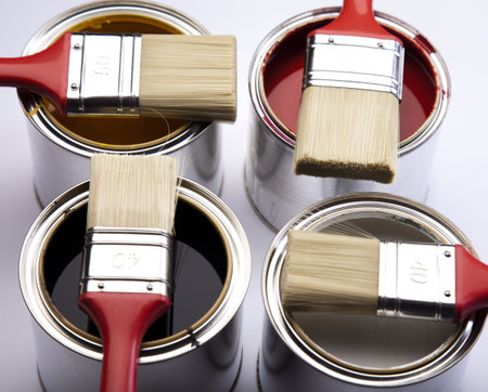 Cans of paint with paintbrush