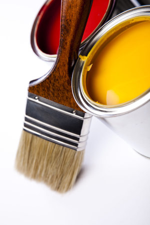 Cans of paint with paintbrush